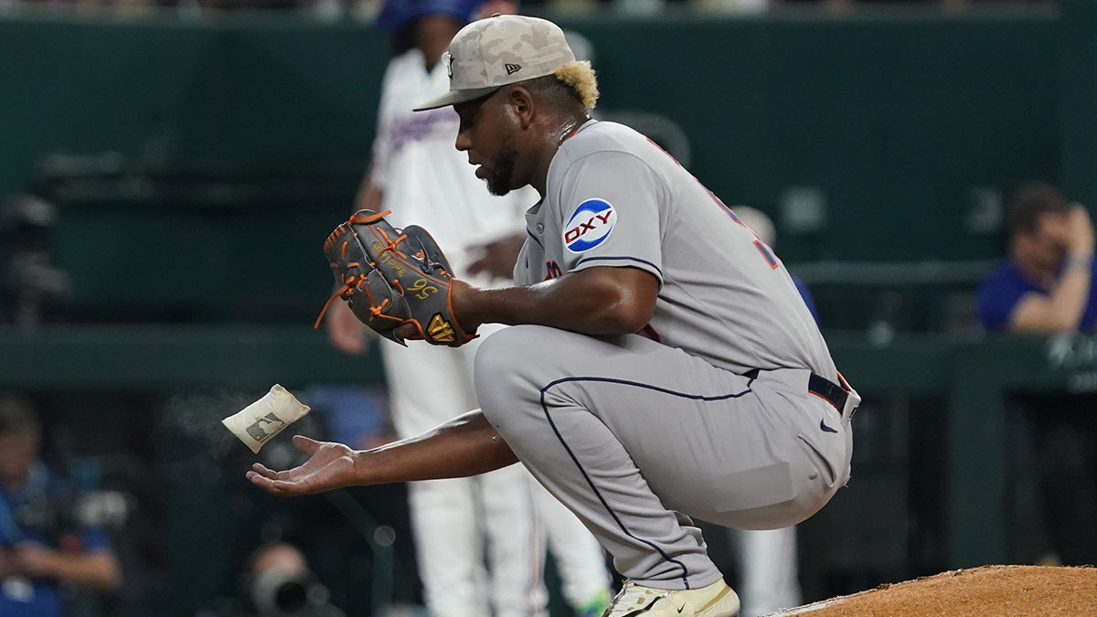 Houston Astros pitcher Ronel Blanco (56) tosses a rosin bag in the air between pitches during the third inning against the Texas Rangers at Globe Life Field.
