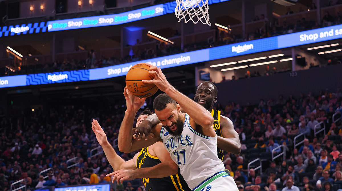 Golden State Warriors forward Draymond Green (23) fouls Minnesota Timberwolves center Rudy Gobert (27) with forward Dario Saric (20) during the second quarter at Chase Center.