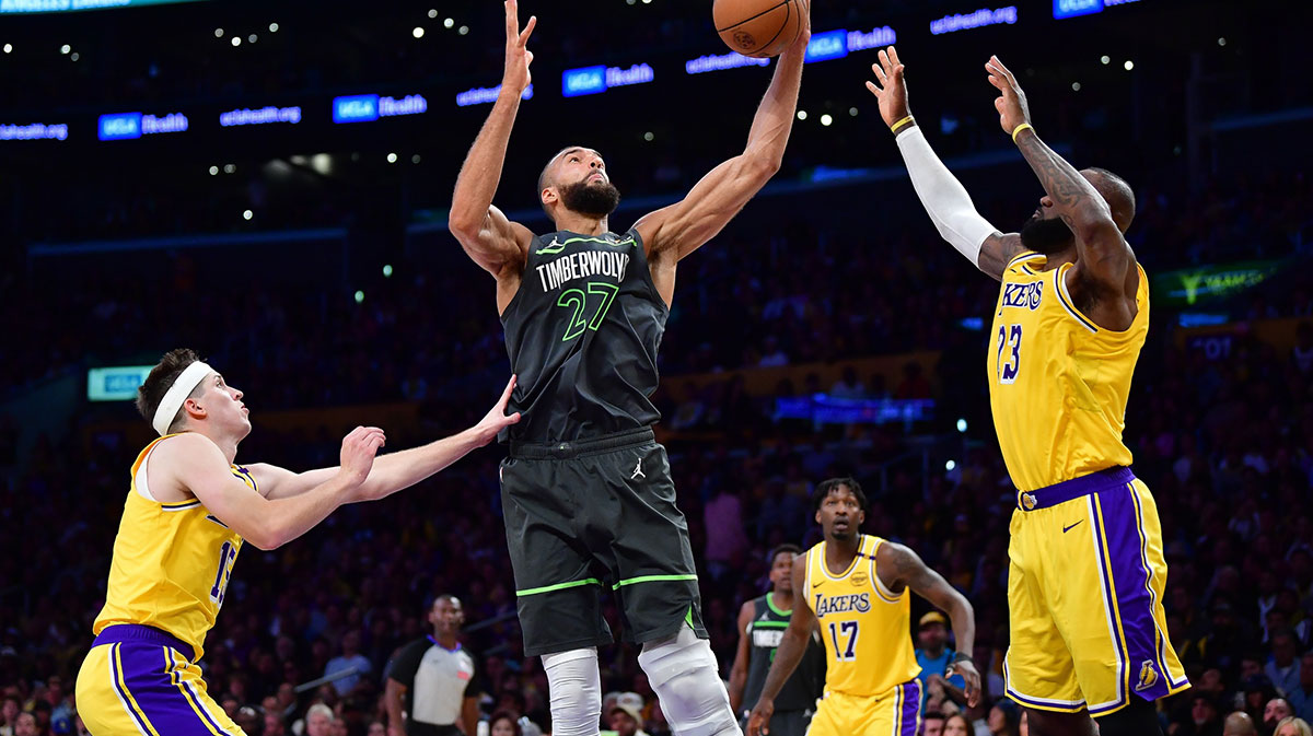 Minnesota Timberwolves center Rudy Gobert (27) gets the rebound against Los Angeles Lakers guard Austin Reaves (15) and forward LeBron James (23) during the second half in game five of first round for the 2025 NBA Playoffs at Crypto.com Arena.