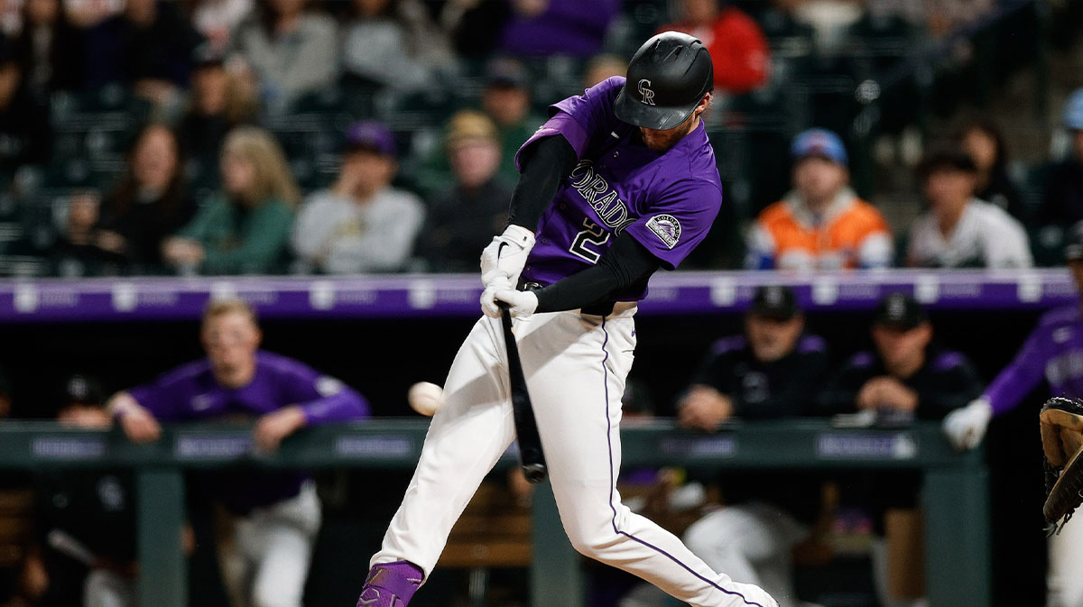 Colorado Rockies pinch hitter Ryan McMahon (24) hits a double in the seventh inning against the Philadelphia Phillies at Coors Field.