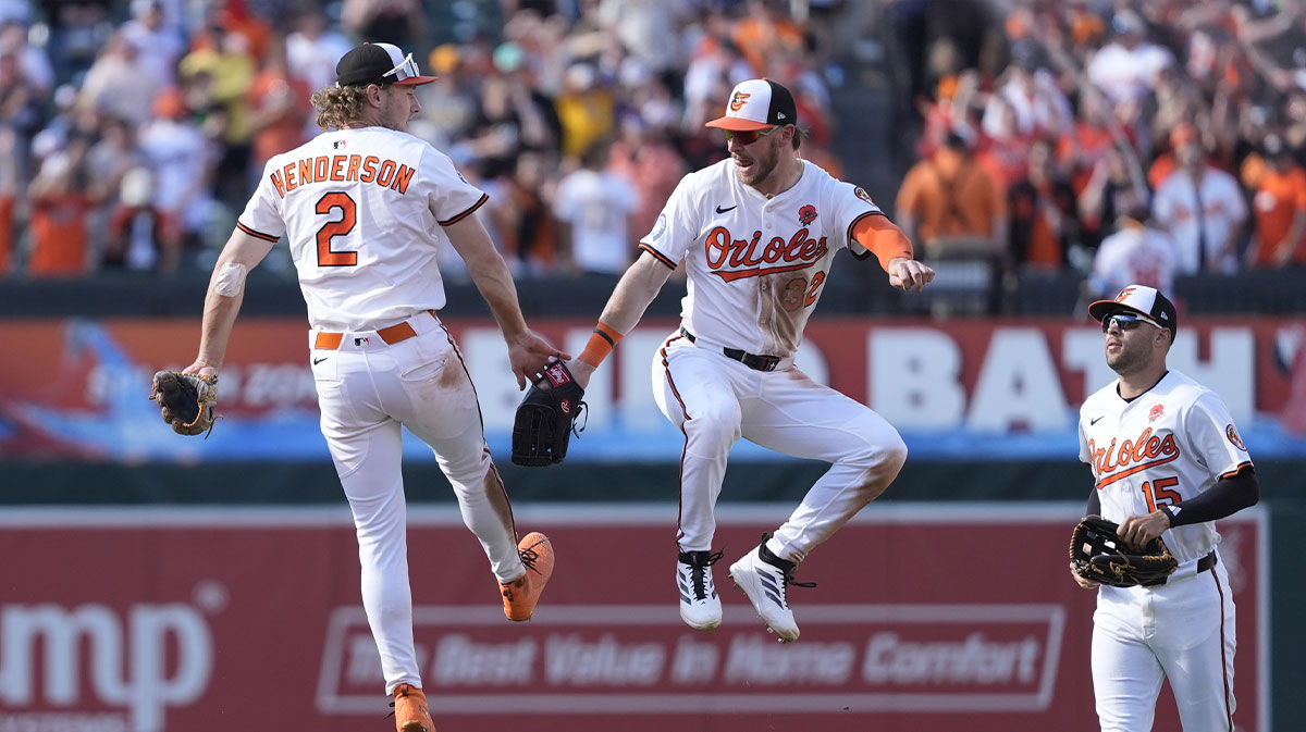 Baltimore Orioles shortstop Gunnar Henderson (2) and right fielder Ryan O'Hearn (32) do a leaping low five to celebrate the victory against the St. Louis Cardinals during the ninth inning at Oriole Park at Camden Yards.
