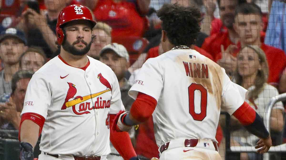 St. Louis Cardinals shortstop Masyn Winn (0) is congratulated by right fielder Alec Burleson (41) after scoring against the Detroit Tigers during the fifth inning at Busch Stadium.