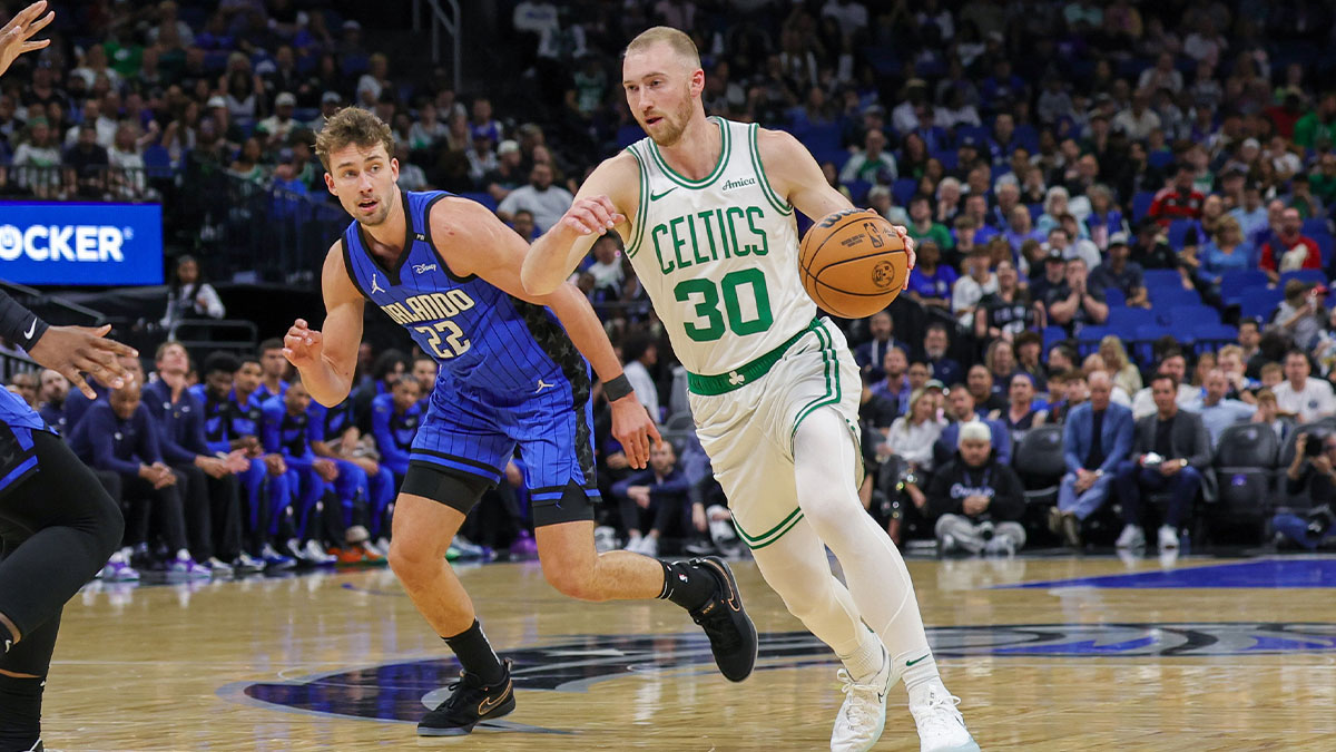 Boston Celtics forward Sam Hauser (30) brings the ball up court in front of Orlando Magic forward Franz Wagner (22) during the first quarter at Kia Center.