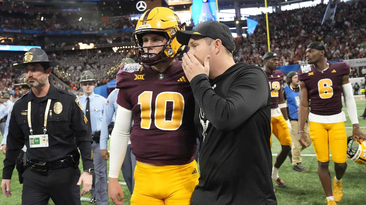 Arizona State head coach Kenny Dillingham whispers to quarterback Sam Leavitt (10) after Texas won 39-31 over Arizona State in double overtime in the Chick-fil-A Peach Bowl in Atlanta on Jan. 1, 2025.