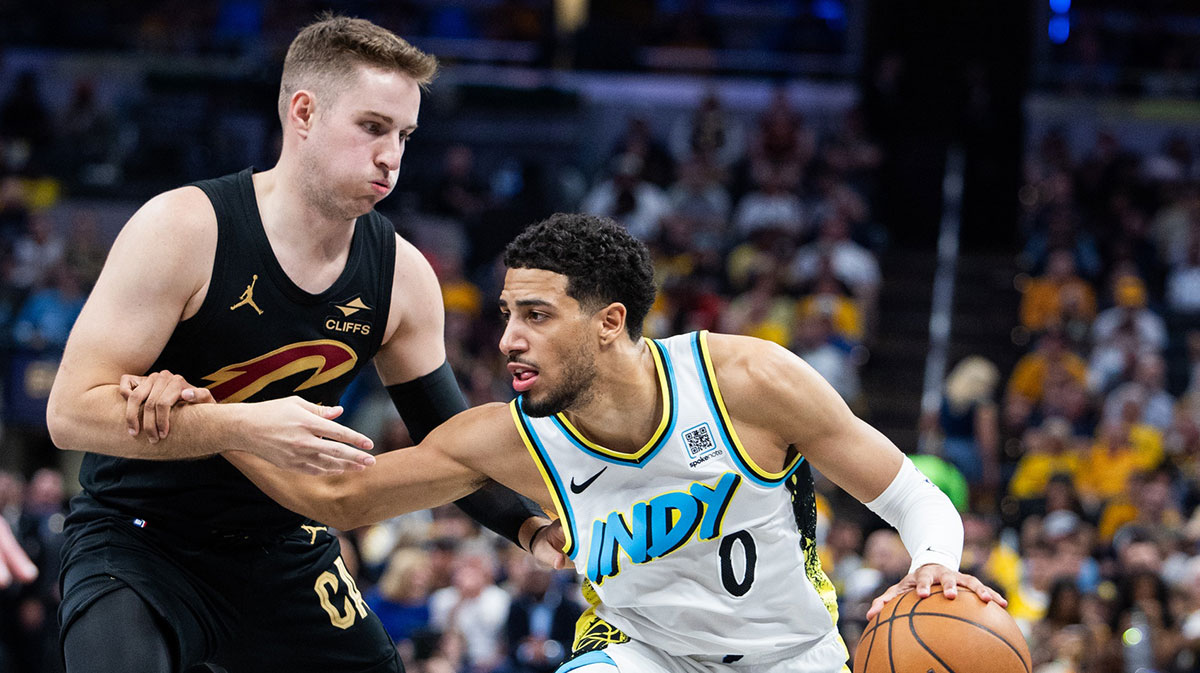 Indiana Pacers guard Tyrese Haliburton (0) dribbles the ball while Cleveland Cavaliers guard Sam Merrill (5) defends during game four of the second round for the 2025 NBA Playoffs at Gainbridge Fieldhouse.