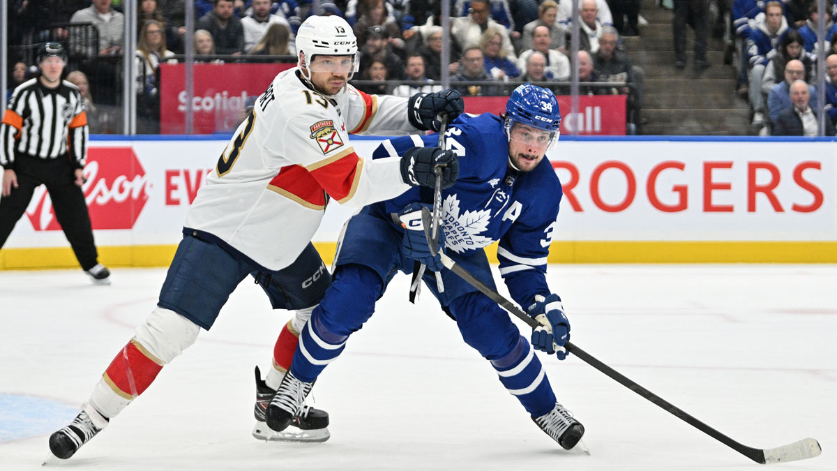 Florida Panthers forward Sam Reinhart (13) pushes on Toronto Maple Leafs forward Auston Matthews (34) in the first period at Scotiabank Arena.