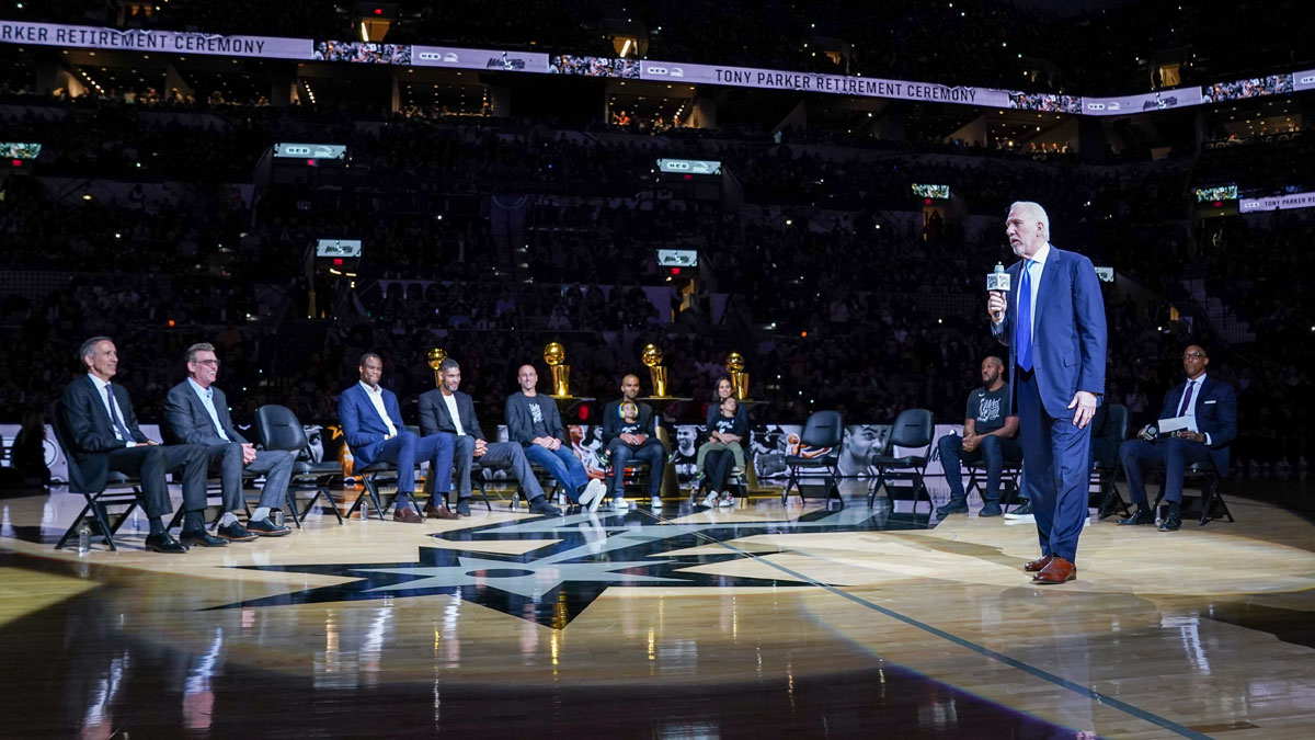 The leader of San Antonio Spurs Gregg Popovich speaks during the Tony Parker's retirement ceremony at the AT&T center. In the photo, the deputy coach of the Spurs Chip Engelland, CEO RC Buford, the former players of Spurs David Robinson, Tim Duncan, Manu Ginobili, Tony Parker, the wife of Parker Axelle Francine, Boris Diaw and Sean Elliott.