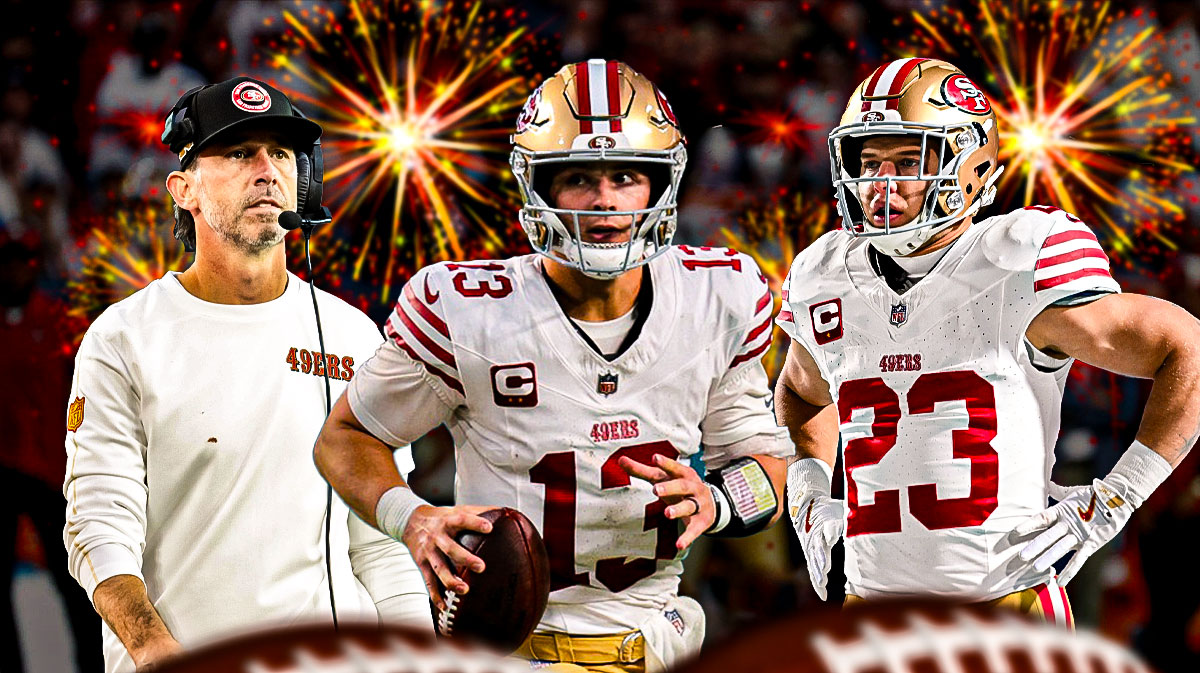 Brock Purdy in the middle, Christian McCaffrey and Coach Kyle Shanahan around him, Dark Cloudy skies in the background