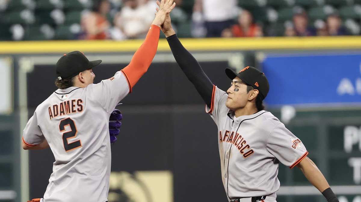 San Francisco Giants shortstop Willy Adames (2) celebrates the win with center fielder Jung Ho Lee (51) against the Houston Astros in the ninth inning at Daikin Park.