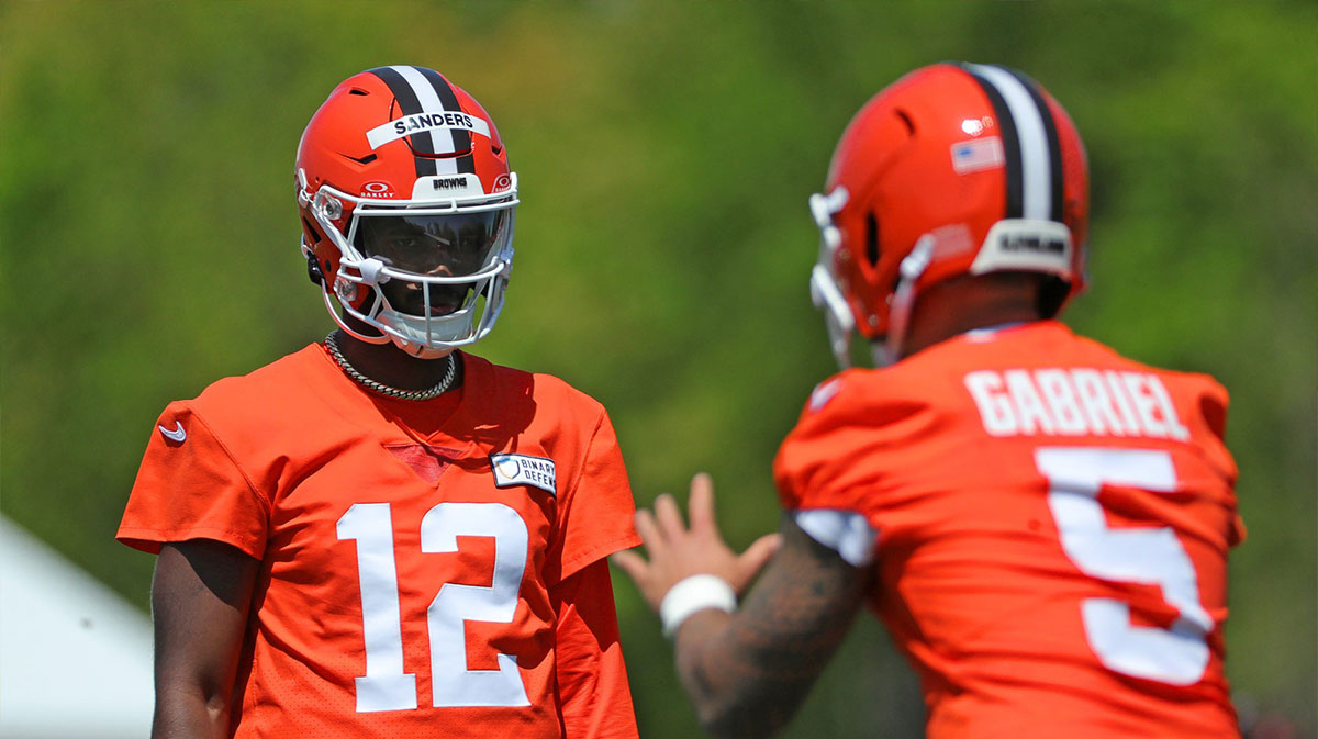 Cleveland Browns quarterback Shedeur Sanders (12) watches quarterback Dillon Gabriel (5) during day two of NFL rookie minicamp at the Cleveland Browns training facility on Saturday, May 10, 2025, in Berea, Ohio.