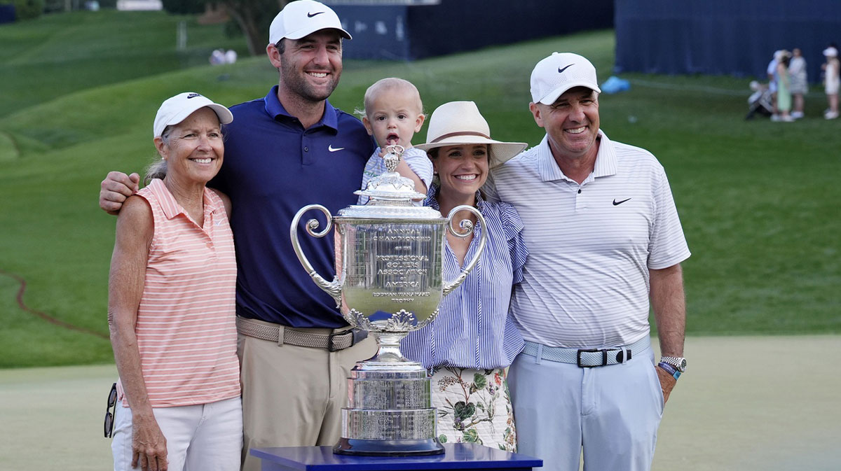 Scottie Scheffler poses for a photo with his mother Diane, father Scott, wife Meredith, and son Bennett after winning the PGA Championship golf tournament at Quail Hollow.