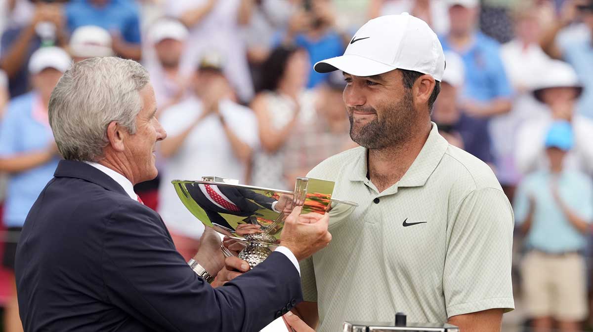 Atlanta, Georgia, USA; PGA TOUR Commissioner Jay Monahan presents Scottie Scheffler the FedEx Cup after winning the TOUR Championship golf tournament.