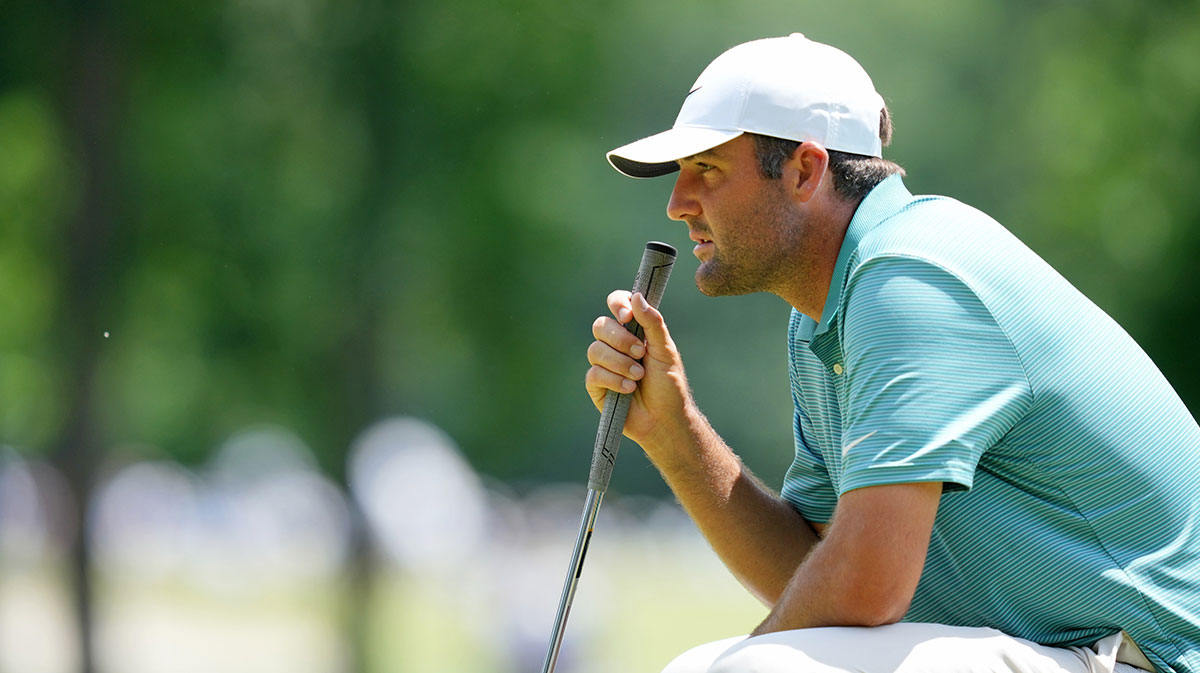 Scottie Scheffler lines up a putt on the third green during the third round of the PGA Championship golf tournament at Quail Hollow.