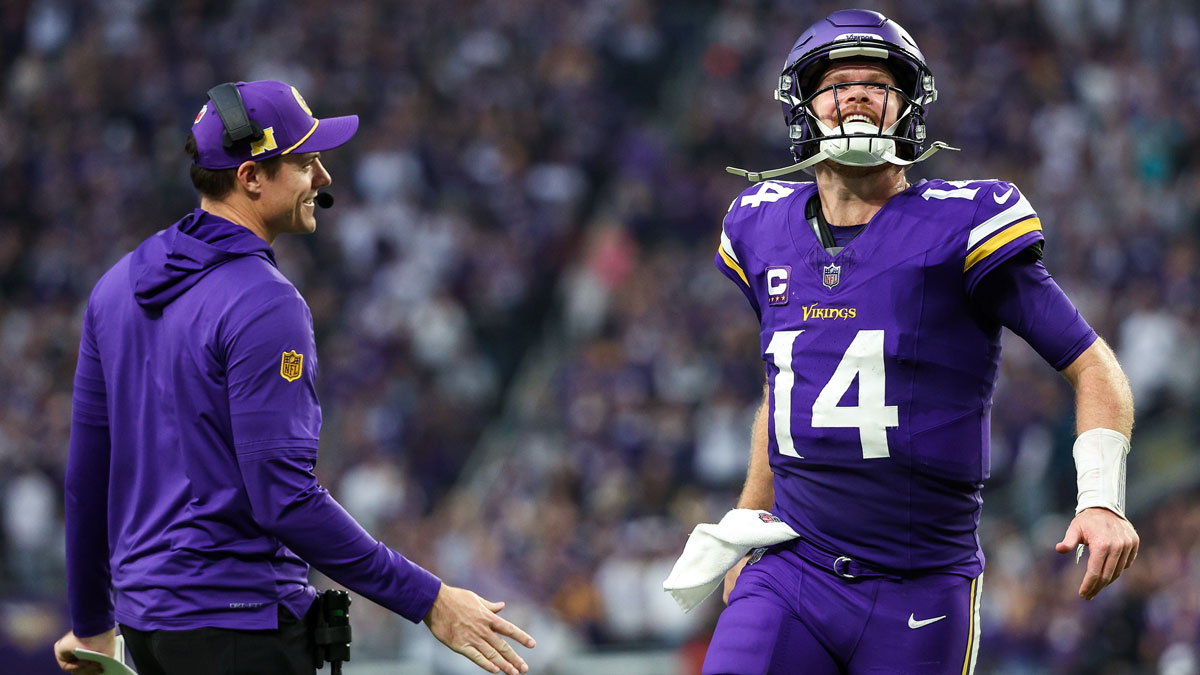 Minnesota Vikings quarterback Sam Darnold (14) celebrates running back Aaron Jones' (33) touchdown run with head coach Kevin O'Connell during the fourth quarter against the Atlanta Falcons at U.S. Bank Stadium.