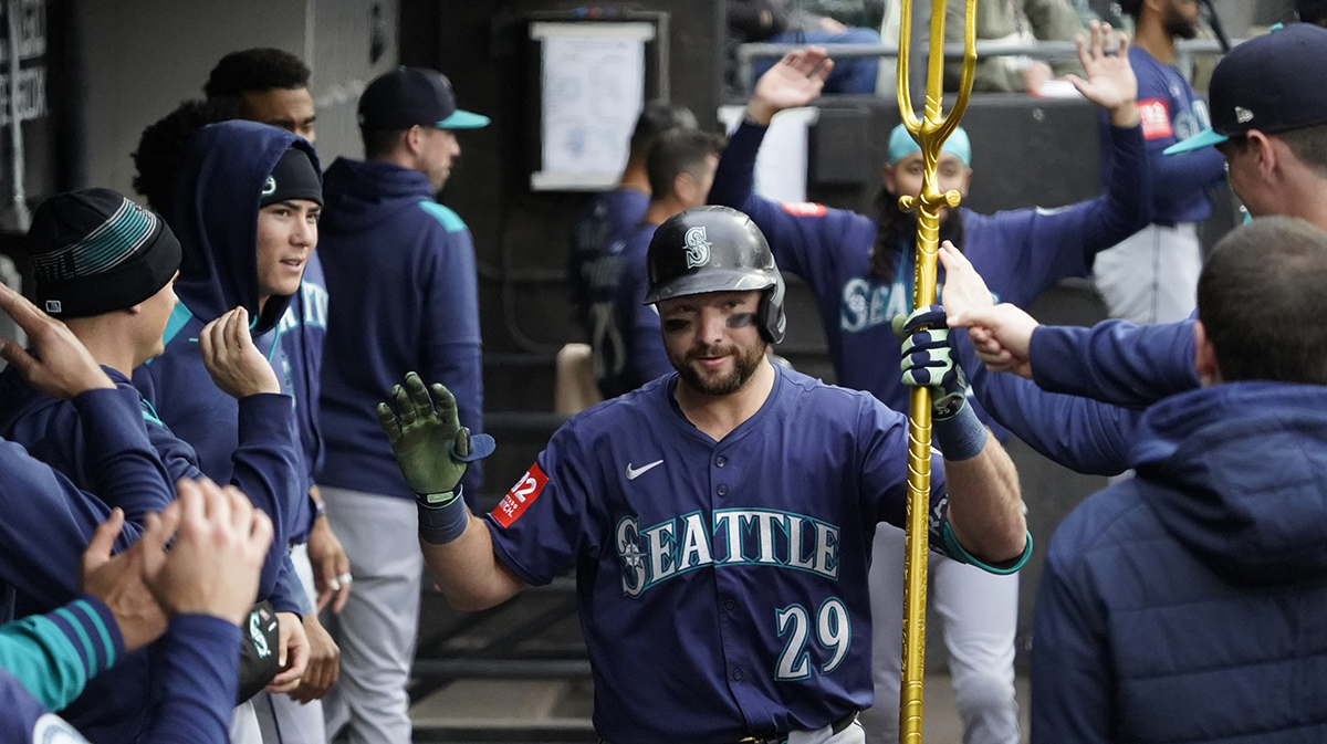 Seattle Mariners catcher Cal Raleigh (29) is greeted in the dugout after hitting a home run against the Chicago White Sox during the sixth inning at Rate Field.