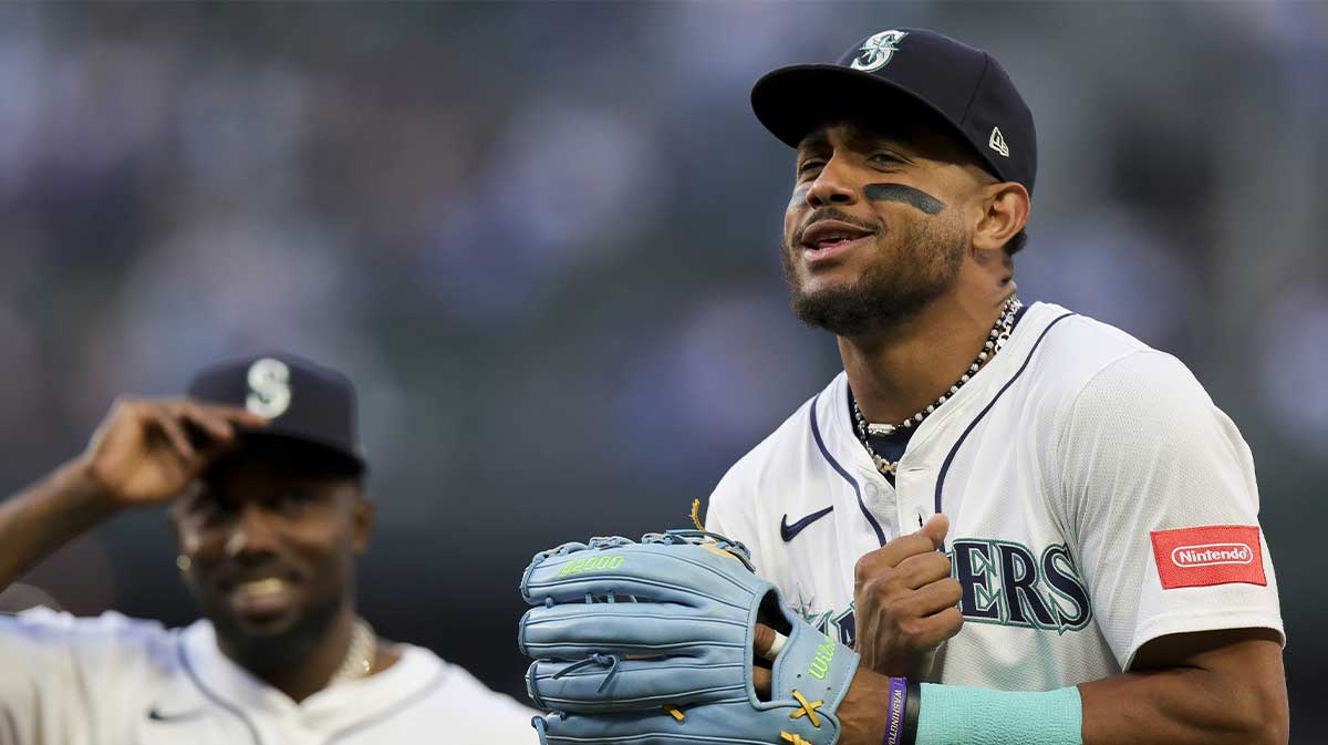 Seattle Mariners center fielder Julio Rodriguez (44), right, reacts while walking off the field with left fielder Randy Arozarena (56) during the third inning of an MLB game against the Miami Marlins at T-Mobile Park.