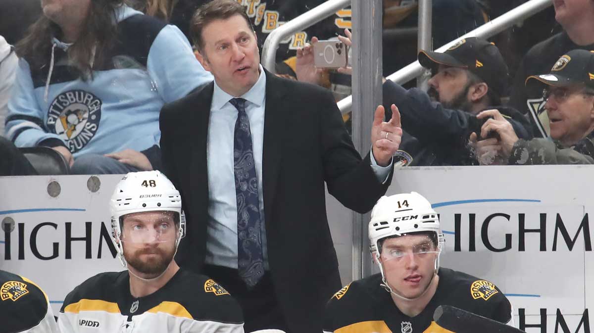 Boston Bruins interim head coach Joe Sacco (rear) reacts on the bench against the Pittsburgh Penguins during the third period at PPG Paints Arena.