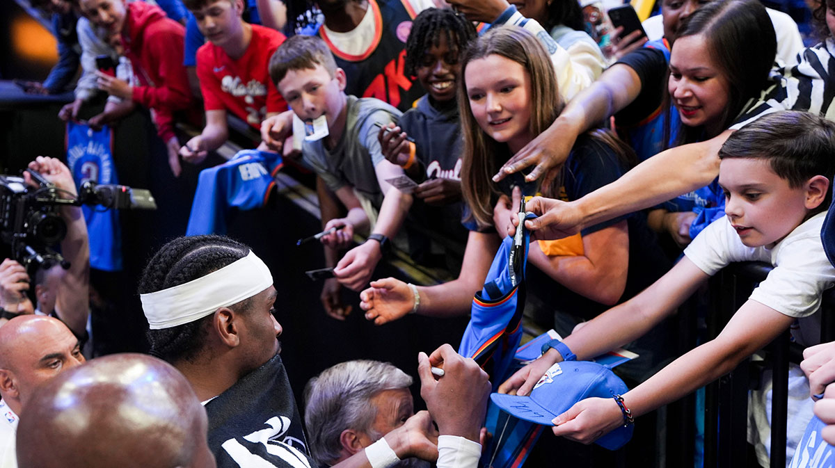 Shai Gilgeous-Alexander (2) signs autographs for fans after the Thunder defeated the Grizzlies 117-115 in Game 4 to win the first-round NBA playoff series.