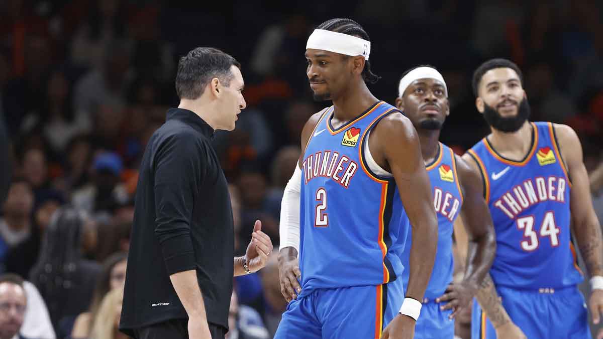Oklahoma City Thunder guard Shai Gilgeous-Alexander (2) and head coach Mark Daigneault talk during a time out against the New Orleans Pelicans during the second quarter at Paycom Center.