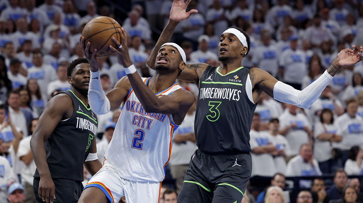 Oklahoma City Thunder guard Shai Gilgeous-Alexander (2) drives against Minnesota Timberwolves forward Jaden McDaniels (3) in the fourth quarter during game one of the western conference finals for the 2025 NBA Playoffs at Paycom Center.