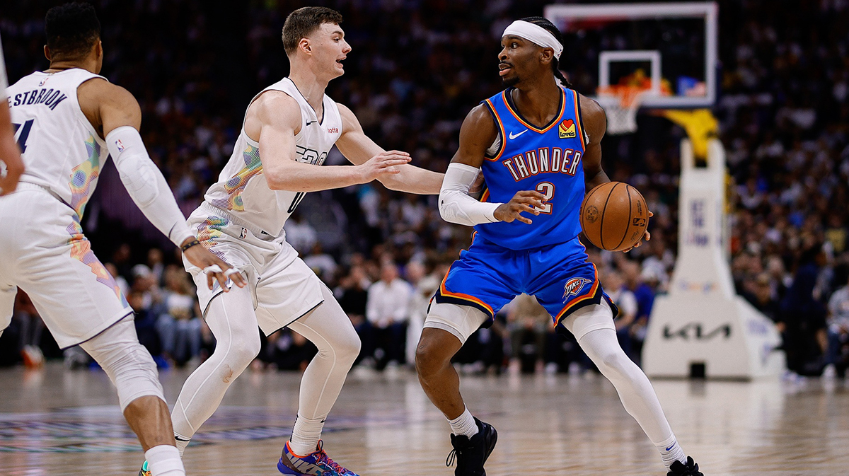 Oklahoma City Thunder guard Shai Gilgeous-Alexander (2) controls the ball as Denver Nuggets guard Christian Braun (0) guards in the second quarter during game six of the second round for the 2025 NBA Playoffs at Ball Arena.