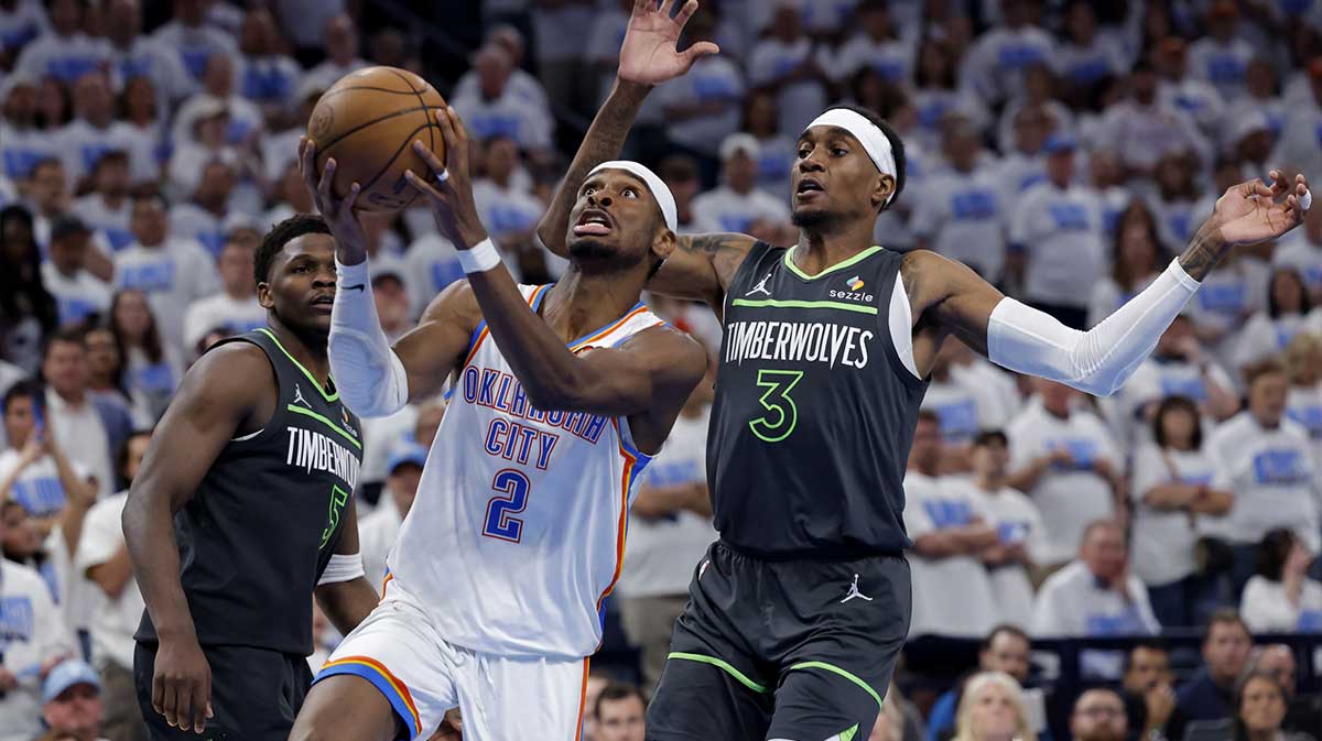 Oklahoma City Thunder guard Shai Gilgeous-Alexander (2) drives against Minnesota Timberwolves forward Jaden McDaniels (3) in the fourth quarter during game one of the western conference finals for the 2025 NBA Playoffs at Paycom Center.