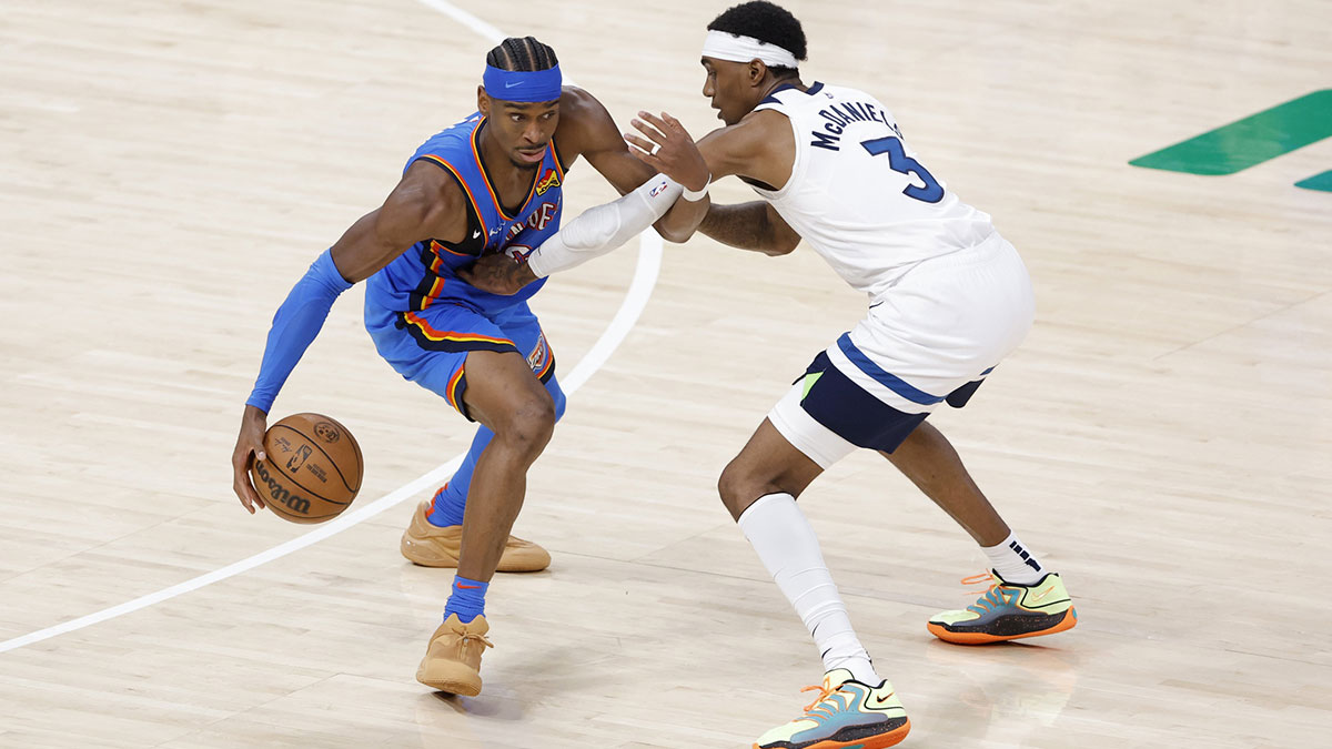 Oklahoma City Thunder guard Shai Gilgeous-Alexander (2) drives against Minnesota Timberwolves forward Jaden McDaniels (3) in the fourth quarter during game two of the western conference finals for the 2025 NBA Playoffs at Paycom Center.