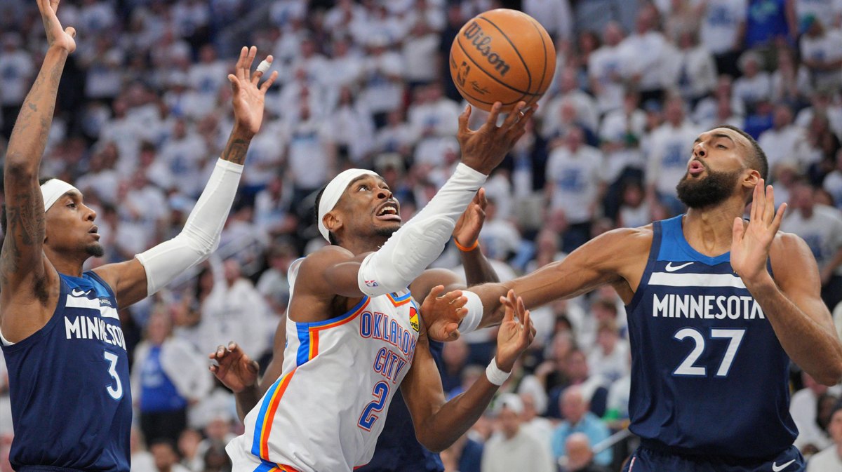 Oklahoma City Thunder guard Shai Gilgeous-Alexander (2) shoots the ball over Minnesota Timberwolves center Rudy Gobert (27) during the first half in game three of the western conference finals for the 2025 NBA Playoffs at Target Center.
