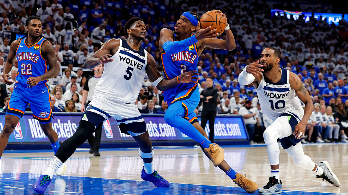 Oklahoma City Thunder guard Shai Gilgeous-Alexander (2) drives to the basket against Minnesota Timberwolves guard Anthony Edwards (5) and guard Mike Conley (10) during the fourth quarter in game five of the western conference finals for the 2025 NBA Playoffs at Paycom Center.