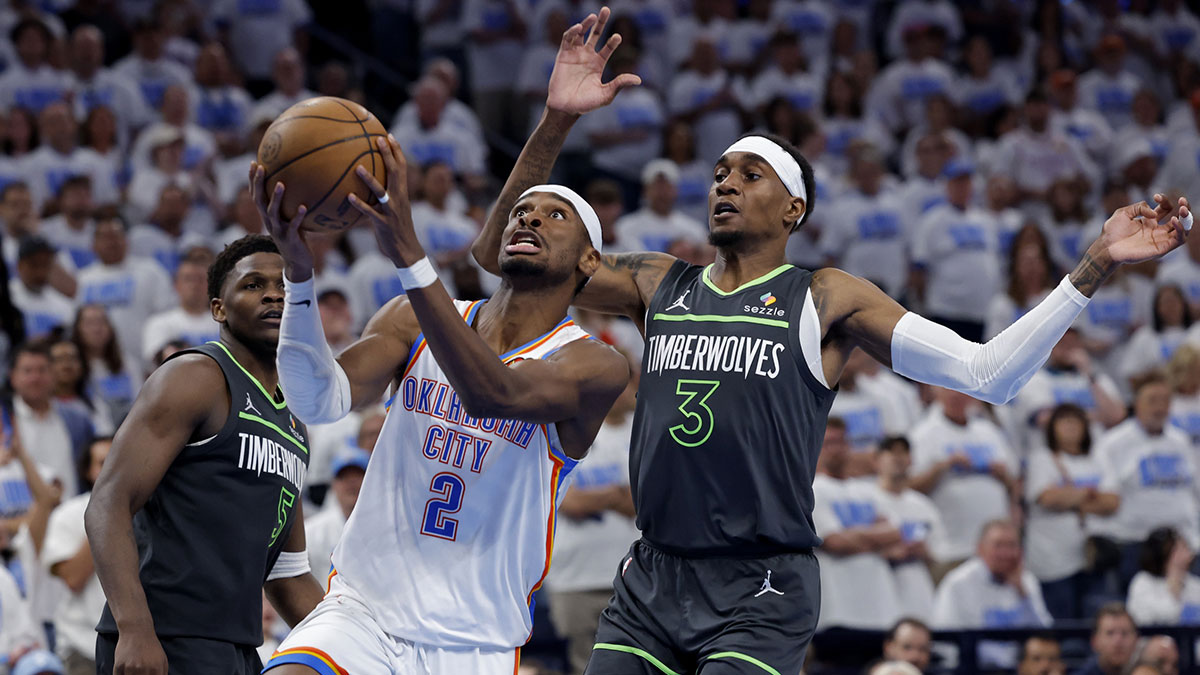 Oklahoma City Thunder guard Shai Gilgeous-Alexander (2) drives against Minnesota Timberwolves forward Jaden McDaniels (3) in the fourth quarter during game one of the western conference finals for the 2025 NBA Playoffs at Paycom Center.