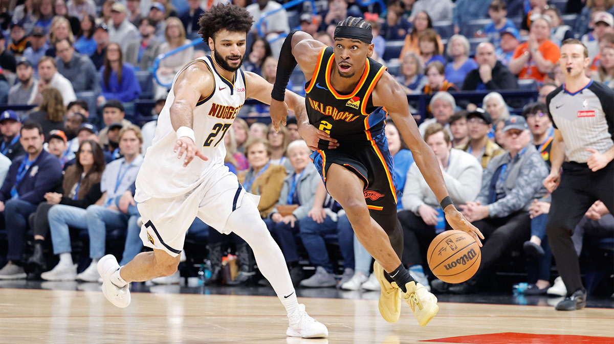 Oklahoma City Thunder guard Shai Gilgeous-Alexander (2) drives around Denver Nuggets guard Jamal Murray (27) during the second half at Paycom Center.