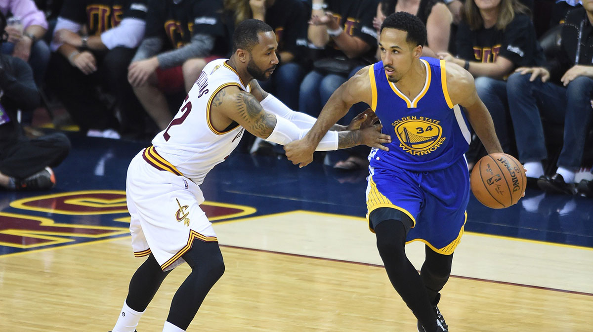 Golden State Warriors guard Shaun Livingston (34) dribbles the ball as Cleveland Cavaliers guard Mo Williams (52) defends during the first quarter in game six of the NBA Finals at Quicken Loans Arena.