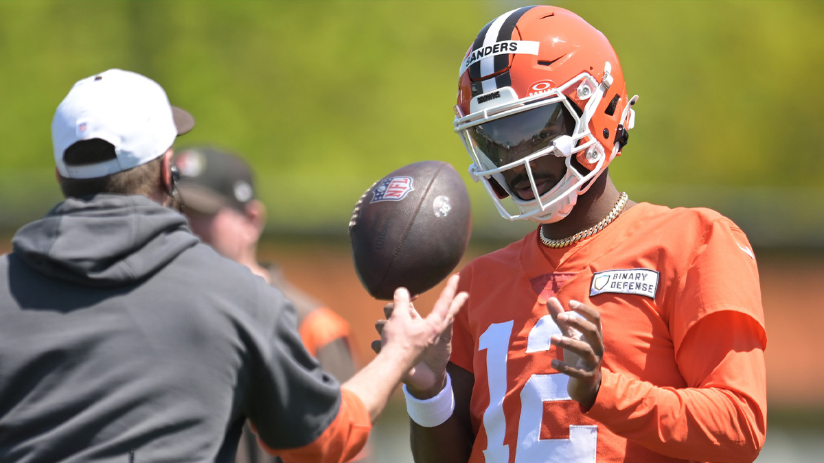 Cleveland Browns quarterback Shedeur Sanders (12) talks to a coach during rookie minicamp.