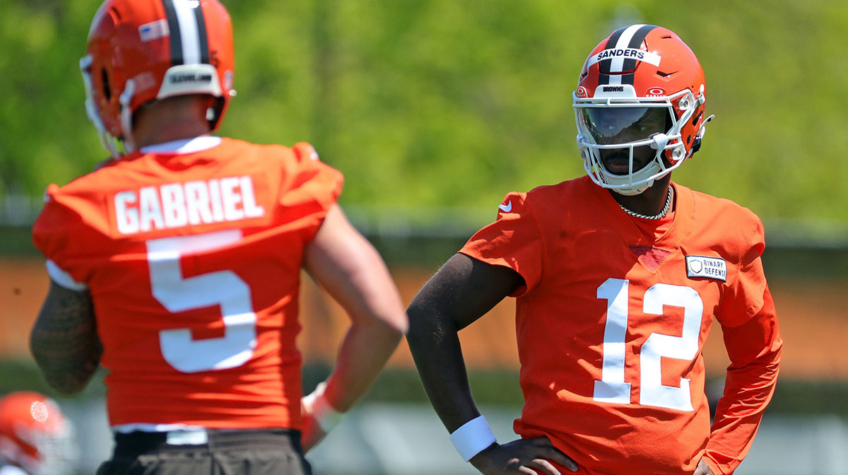 Cleveland Browns quarterback Shedeur Sanders (12) watches quarterback Dillon Gabriel (5) during day two of NFL rookie minicamp at the Cleveland Browns training facility on Saturday, May 10, 2025, in Berea, Ohio.