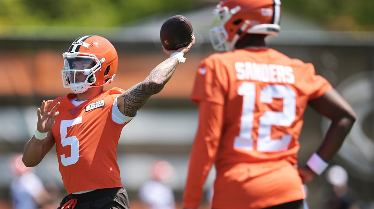 Cleveland Browns quarterback Dillon Gabriel (5) passes as quarterback Shedeur Sanders (12) looks on during rookie minicamp at CrossCountry Mortgage Campus.