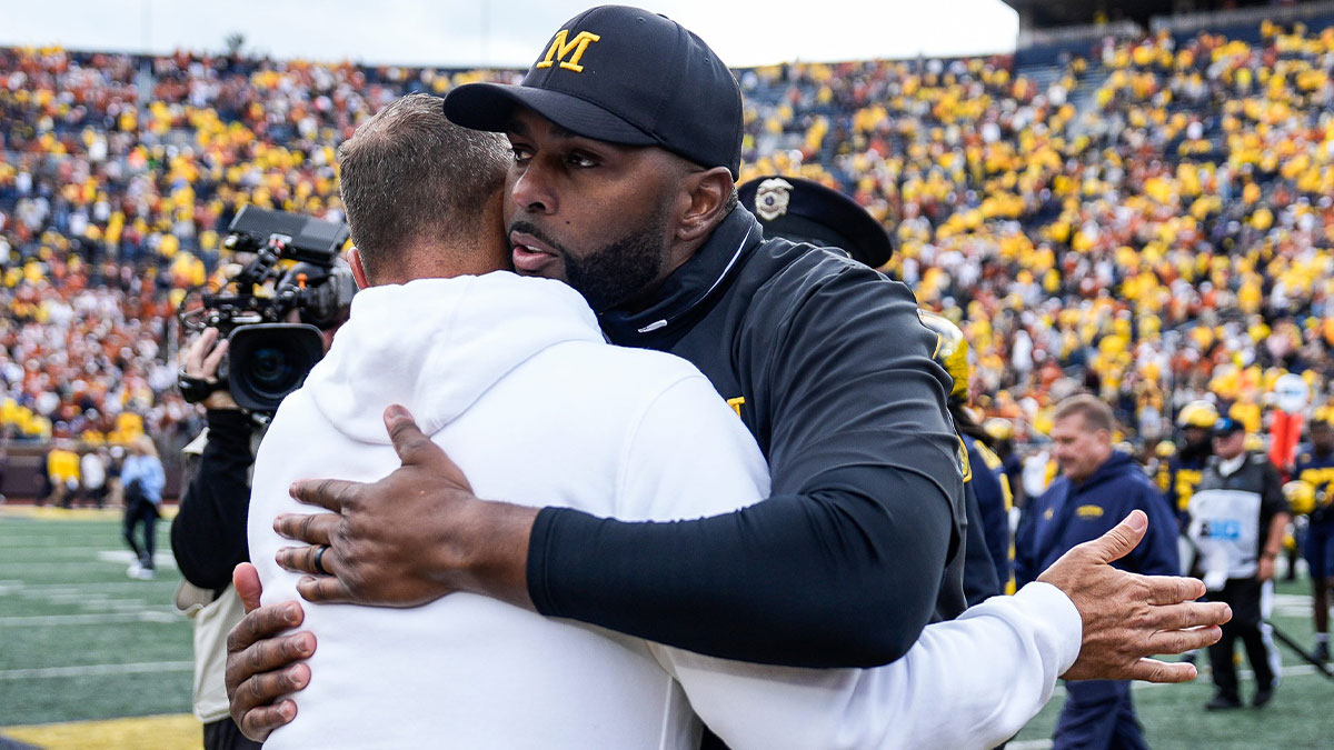 Michigan head coach Sherrone Moore hugs Texas head coach Steve Sarkisian after 31-12 loss at Michigan Stadium