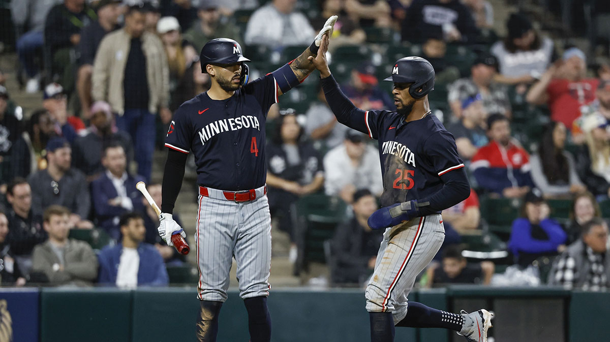 Minnesota Twins outfielder Byron Buxton (25) celebrates with shortstop Carlos Correa (4) after scoring against the Chicago White Sox during the ninth inning at Guaranteed Rate Field.