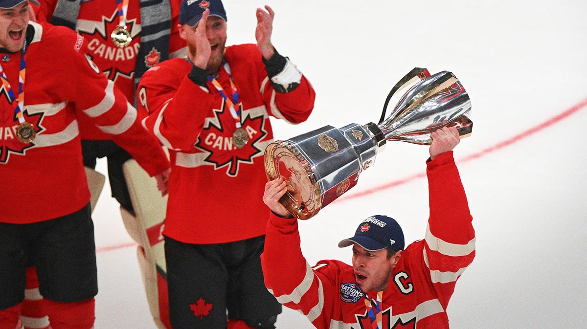 Team Canada forward Sidney Crosby (87) lifts the 4 Nations Face-Off trophy after winning against Team USA in overtime during the 4 Nations Face-Off ice hockey championship game at TD Garden.