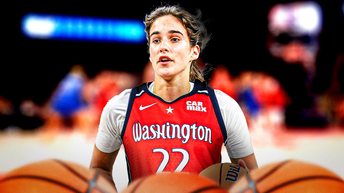Sonia Citron smiles and holds basketball in Mystics jersey