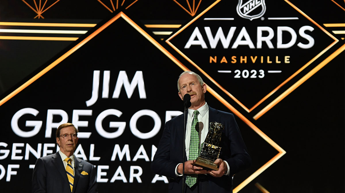 Dallas Stars general manager Jim Nill is awarded the Jim Gregory General Manager of the Year award by Nashville Predators general manager David Poile during the first round of the 2023 NHL Draft at Bridgestone Arena.