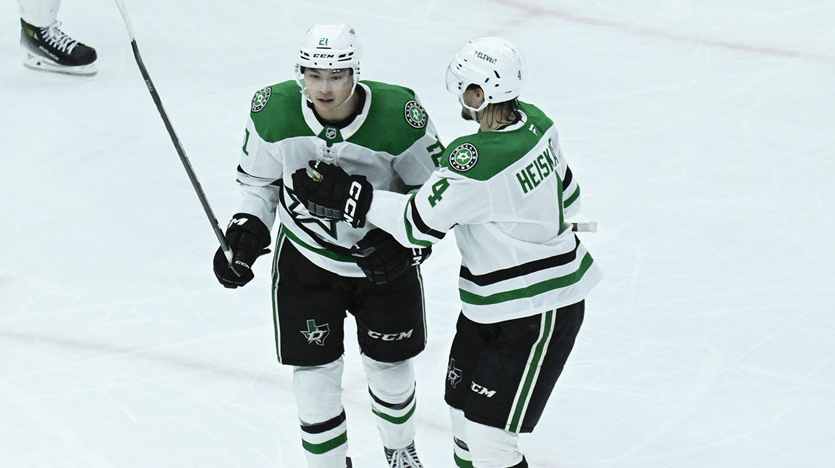 Dallas Stars left wing Jason Robertson (21) reacts with defenseman Miro Heiskanen (4) after he scores a goal against the Chicago Blackhawks during the second period at United Center.
