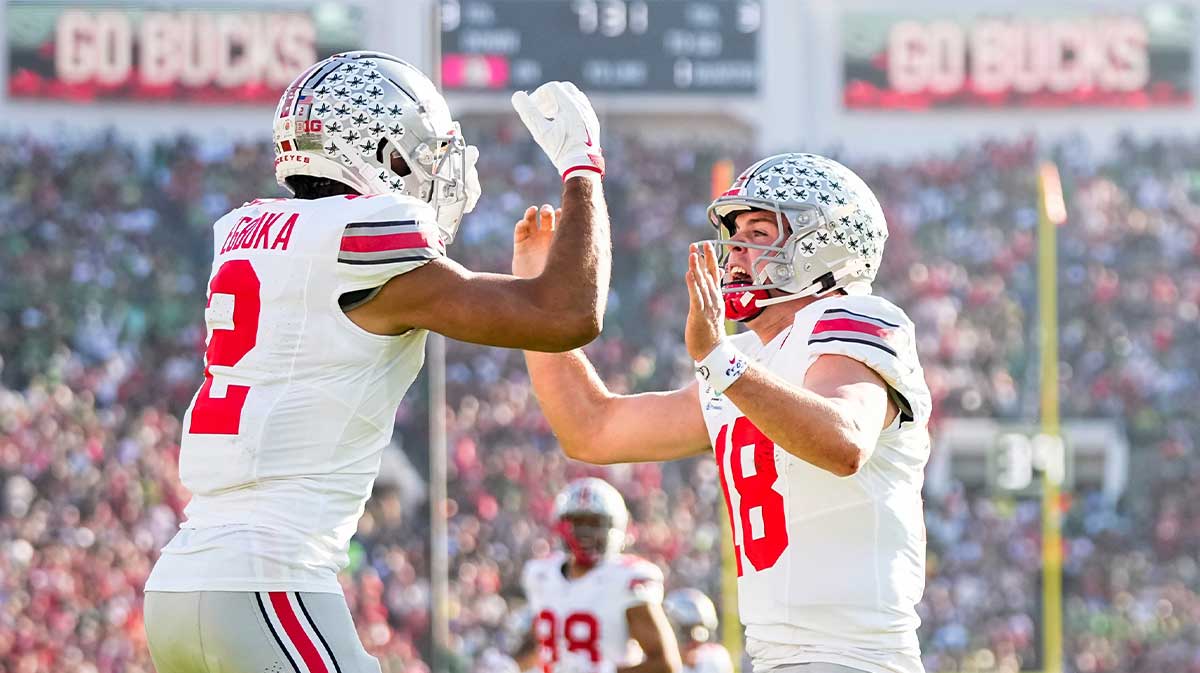 Ohio State Buckeyes wide receiver Emeka Egbuka (2) celebrates a touchdown catch with quarterback Will Howard (18) during the first half of the College Football Playoff quarterfinal against the Oregon Ducks at the Rose Bowl in Pasadena, Calif. on Jan. 1, 2025.