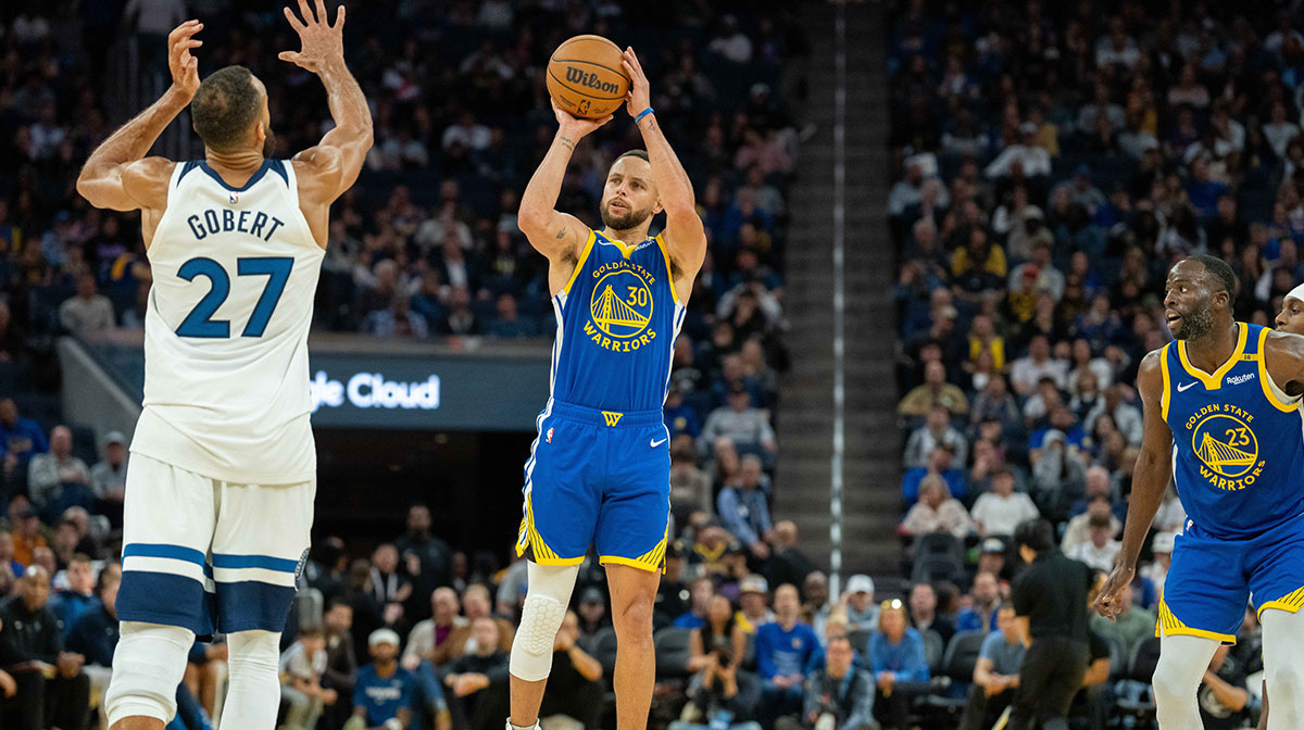 Golden State Warriors guard Stephen Curry (30) shoots a three point shot against Minnesota Timberwolves center Rudy Gobert (27) during the fourth quarter at Chase Center.