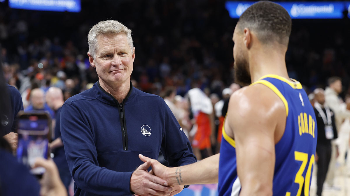 Golden State Warriors head coach Steve Kerr celebrates with guard Stephen Curry (30) after their team defeated the Oklahoma City Thunder at Paycom Center.