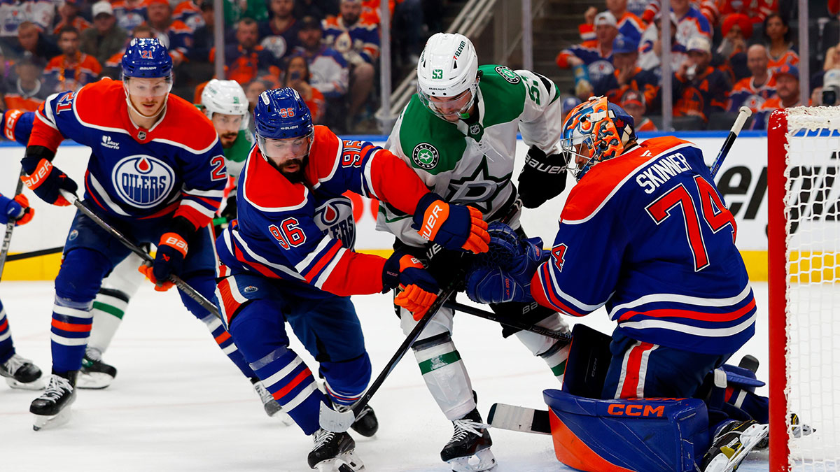 Dallas Stars center Wyatt Johnston (53) tries to poke the puck past Edmonton Oilers defenseman Jake Walman (96) and goaltender Stuart Skinner (74) during the second period in game three of the Western Conference Final of the 2025 Stanley Cup Playoffs at Rogers Place.