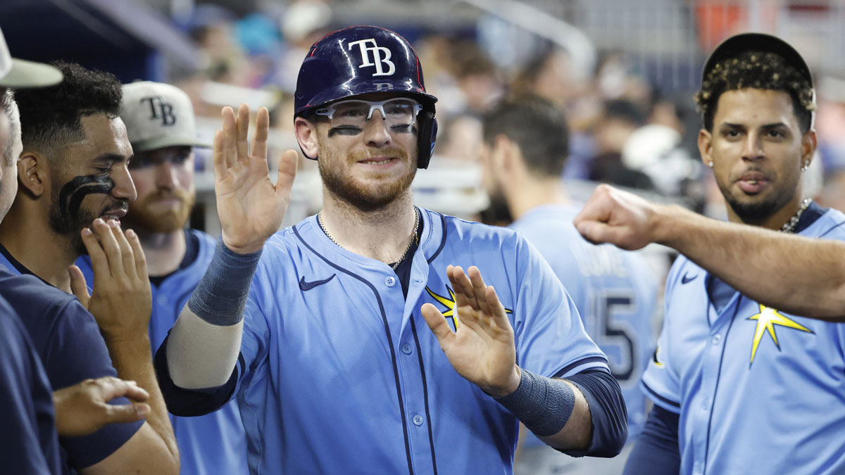 Tampa Bay Rays catcher Danny Jansen (19) is greeted in the dugout by teammates after scoring against the Miami Marlins during the fifth inning at loanDepot Park.