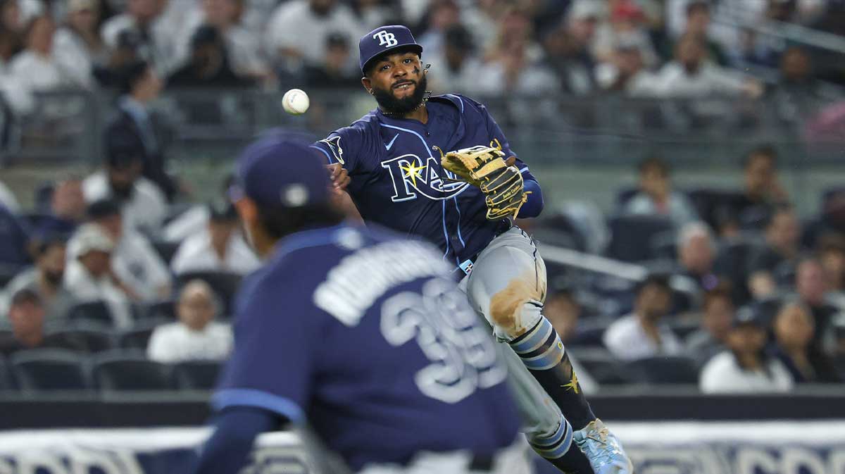 Tampa Bay Rays third baseman Junior Caminero (13) throws the ball to first base for an out in front of relief pitcher Manuel Rodriguez (39) during the seventh inning against the New York Yankees at Yankee Stadium.