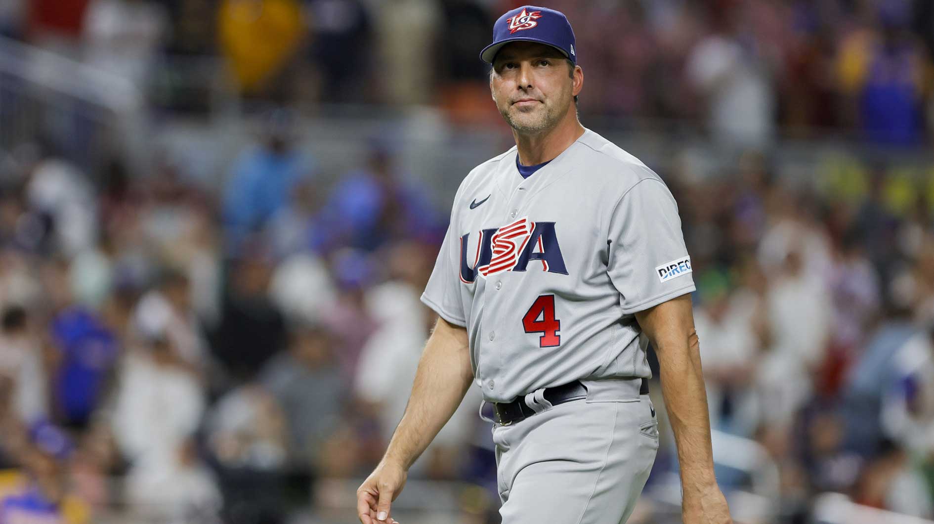 USA manager Mark DeRosa (4) returns to the dugout after a pitching change during the fifth inning against Venezuela at LoanDepot Park.