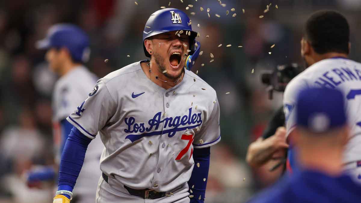 Los Angeles Dodgers shortstop Miguel Rojas (72) celebrates with right fielder Teoscar Hernandez (37) after a home run against the Atlanta Braves in the seventh inning at Truist Park.
