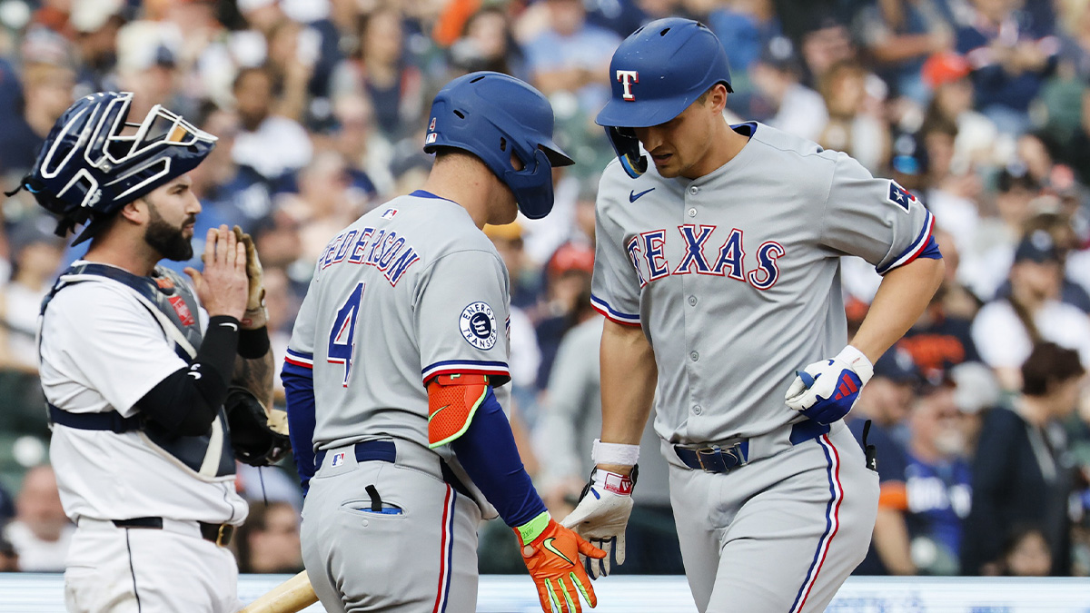 Texas Rangers shortstop Corey Seager (5) receives congratulations from designated hitter Joc Pederson (4) after he hits a home run in the first inning against the Detroit Tigers at Comerica Park.